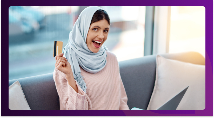 Middle Eastern individual using a laptop for digital banking activities, showcasing secure online financial services.